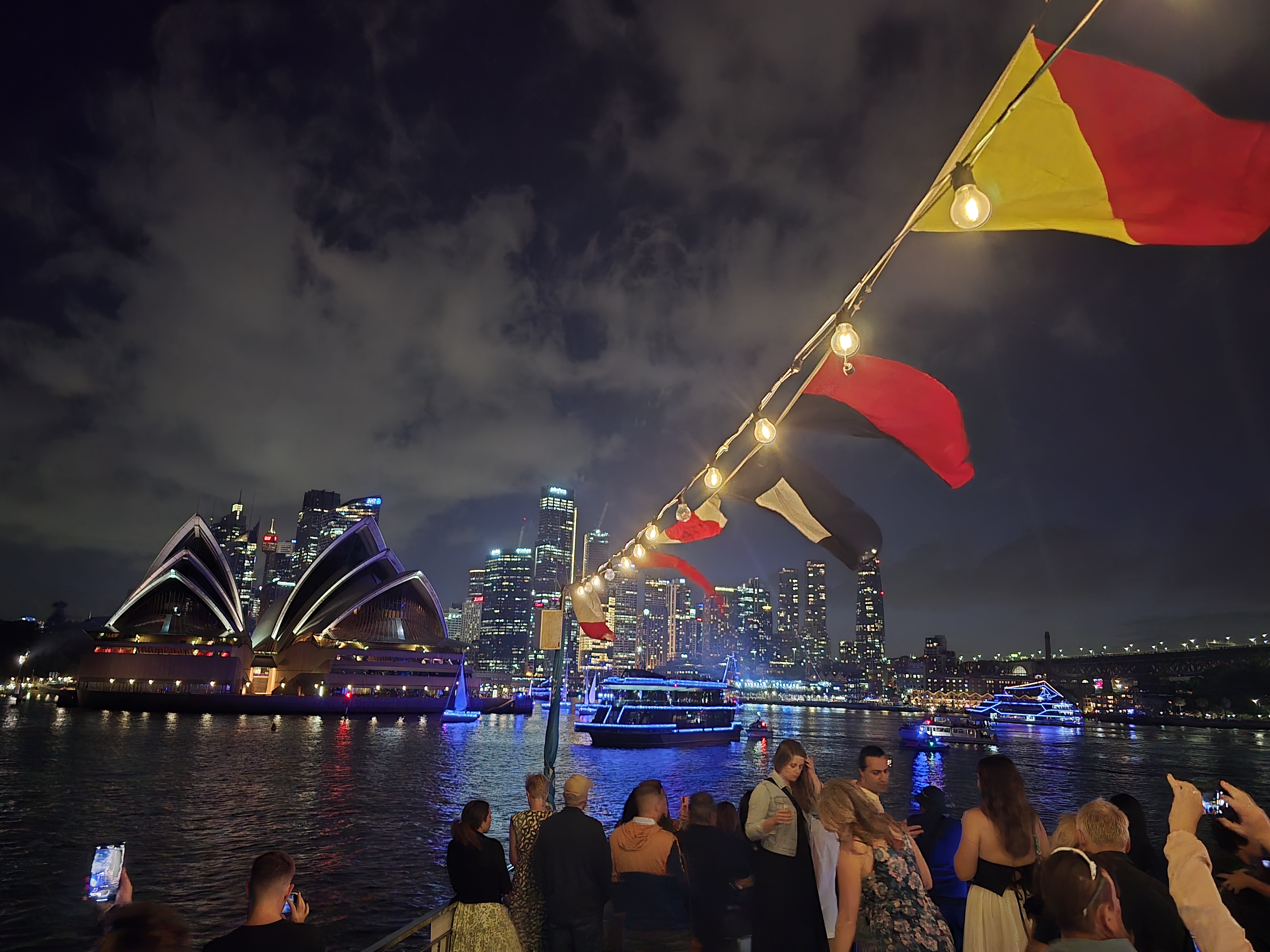 Vivid Sydney harbour cruise – panoramic deck view of Opera House and city lights